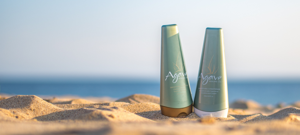 Agave Shampoo and Conditioner Essentials on a sandy beach